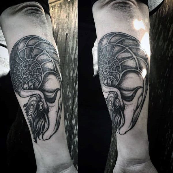 Man With Seashell Forearm Tattoo Spiral Design