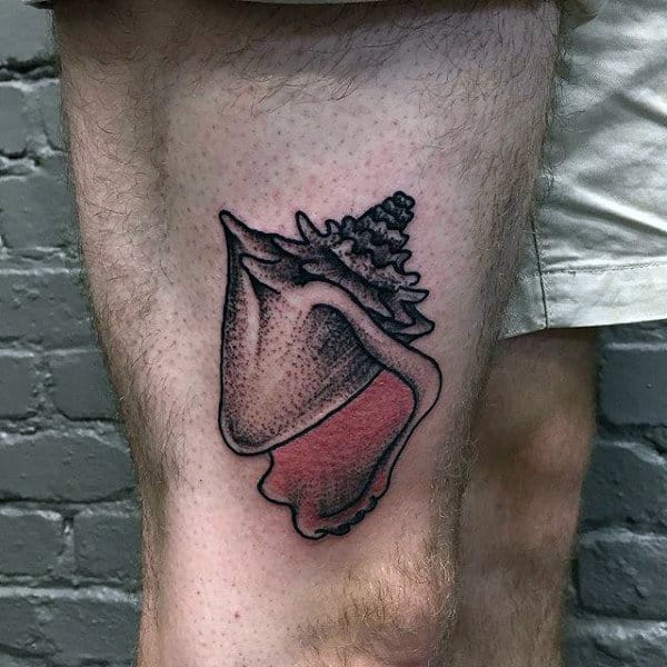 Man With Seashell Tattoo On Upper Thigh