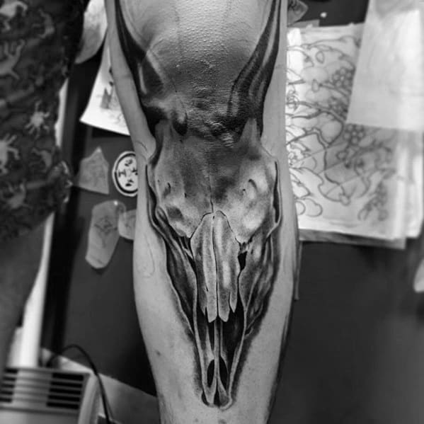 Man With Shin And Knee Goat Skull Tattoo