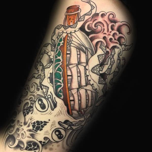 Man With Ship In A Bottle And Octopus Tattoo On Arm