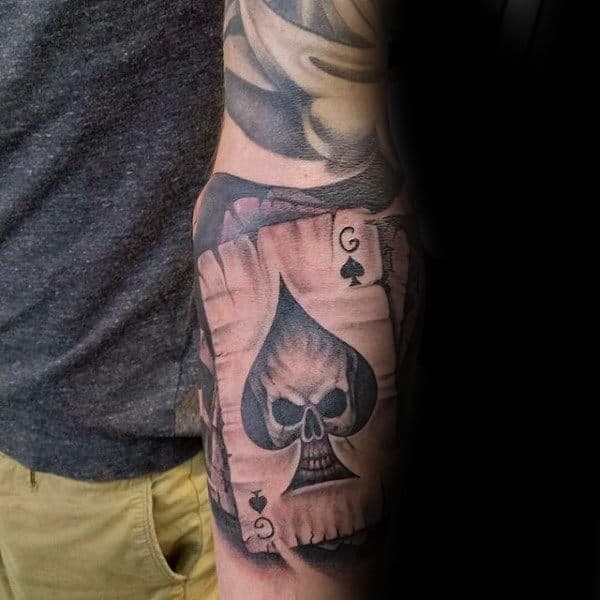 Man With Skull Spade Playing Card Arm Tattoo