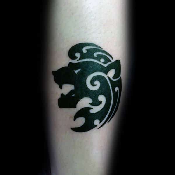Man With Tattoo Design Of Small Tribal Lion On Forearm