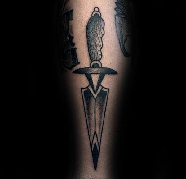 Man With Tattoo Of Dagger On Leg Traditional Design Style
