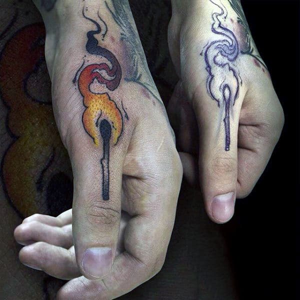 man-with-tattoo-on-finger-of-match-on-fire