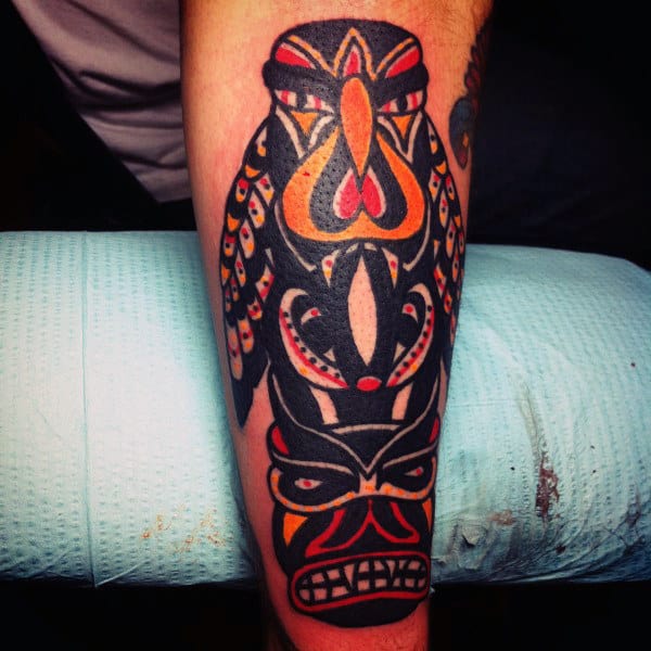 Man With Thick Line Tribal Style Totem Pole Forearm Tattoo