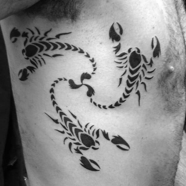 Man With Three Tribal Scorpions Tattoo On Rib Cage Side Tattoo