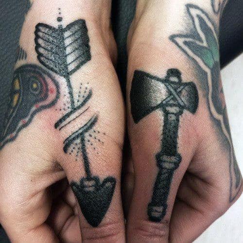 Man With Thumb Tattoo Of Arrow And Axe