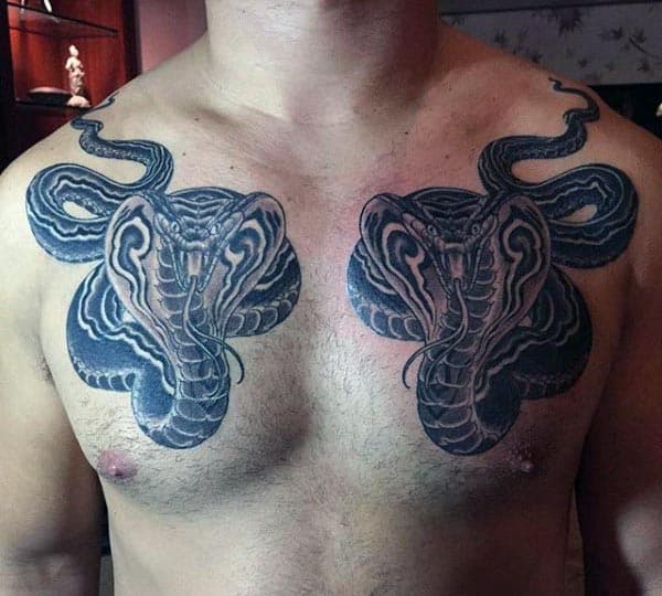 Man With Two Cobra Snakes Tattoo On Chest