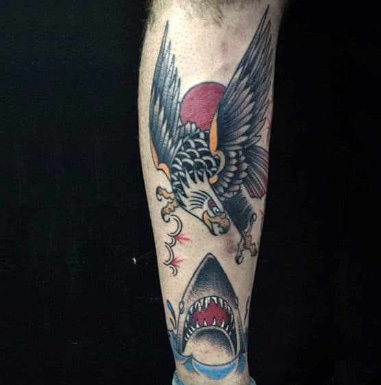 Man With War Between Bald Eagle And Shark Tattoo On Forearm