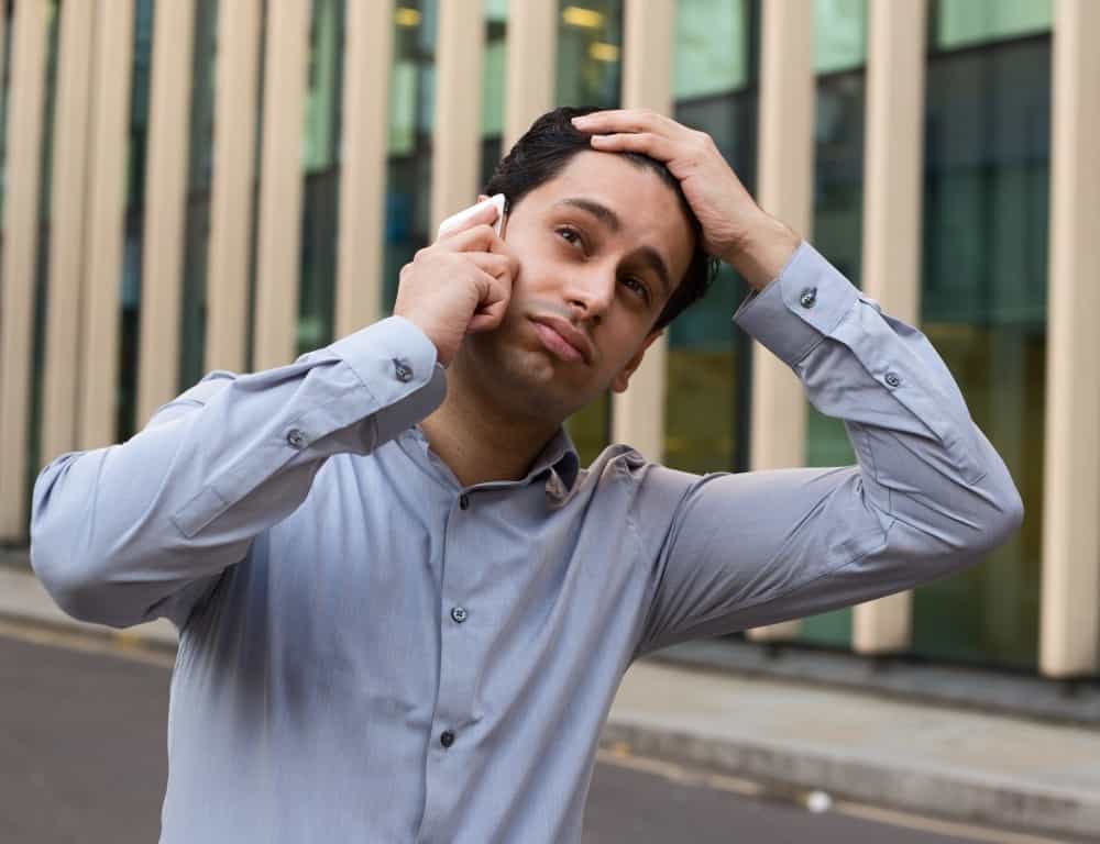 man worries while calling on the phone