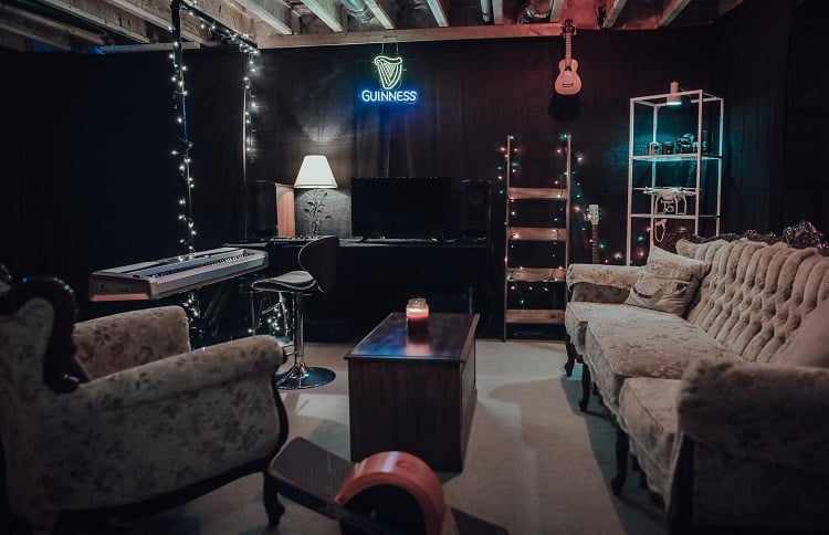 music room basement keyboard vintage sofas guinness sign 