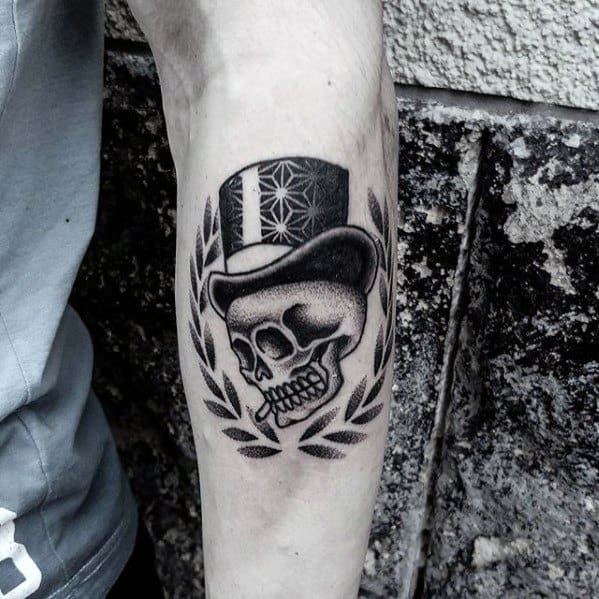 Manly Geometric Skull With Top Hat And Laurel Wreath Tattoo Design Ideas For Men On Inner Forearm
