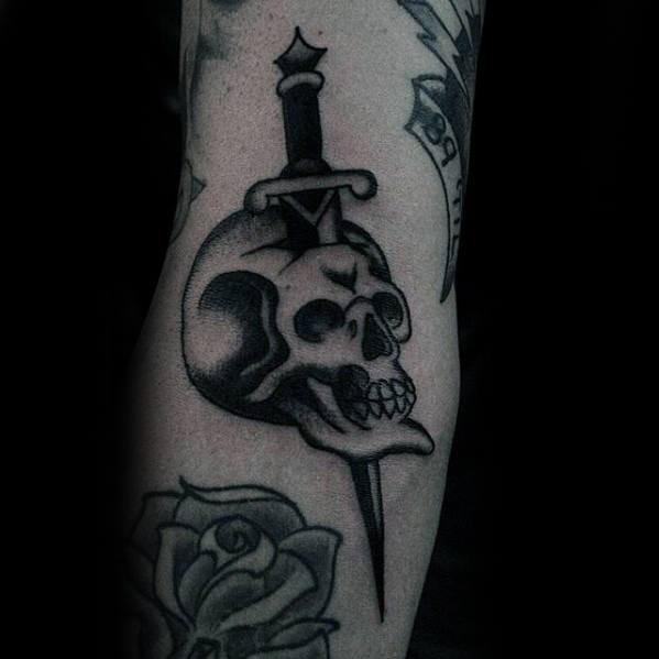 Manly Skull With Dagger Sword Ditch Tattoo Design Ideas For Men