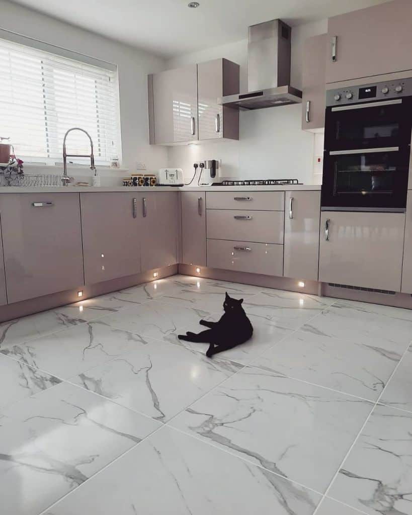 pink cabinet kitchen white marble tile floor led undershelf lighting 