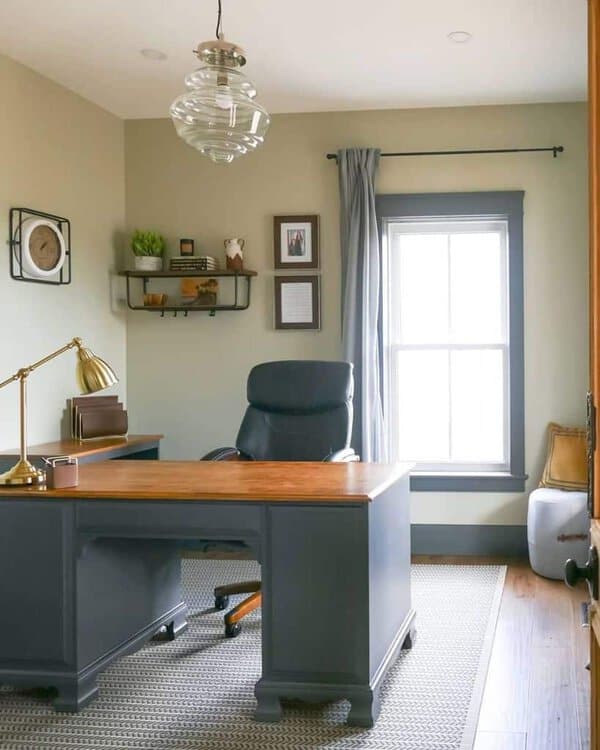 simple modern office gray desk with wood countertop wall shelves gray wall trim gold lamp