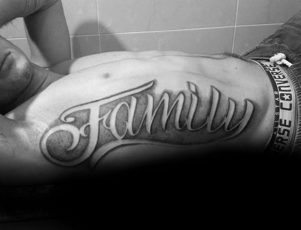 Masculine Script Full Rib Cage Side Family Word Tattoo On Male