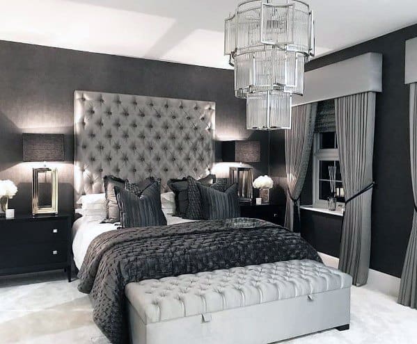 gray master bedroom with unique chandelier