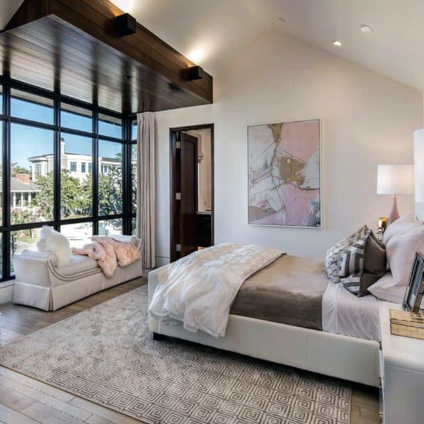 modern master bedroom with floor to ceiling windows 