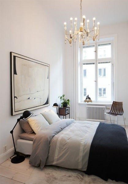 small minimalist apartment bedroom with  chandelier