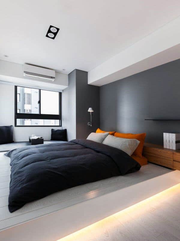 large gray apartment bedroom with platform bed 