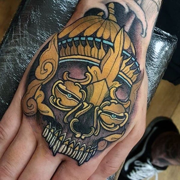 Mens Gold Hand Tattoo Ideas With Tibetan Skull Design