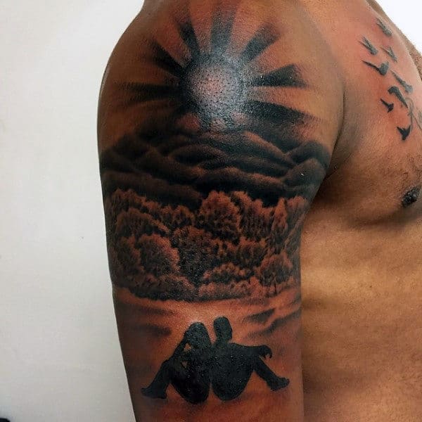 Mens Rising Sun Tattoo With Couple In Background On Arm