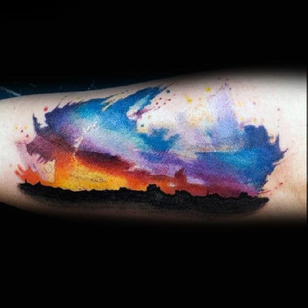 Mens Skyline Silhousette Forearm Tattoo With Dramatic Sunset