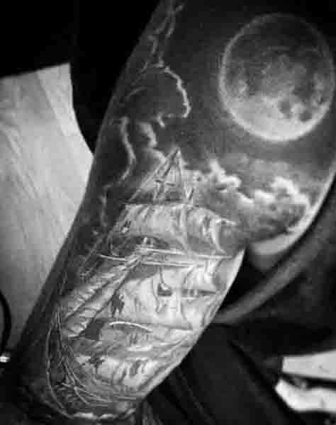 Mens Sleeve Tattoo Of Sailing Ship With Moon And Clouds On Upper Arm