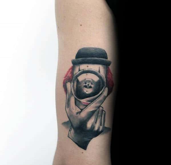 Mens Small Clown With Camera Tricep Tattoo Design