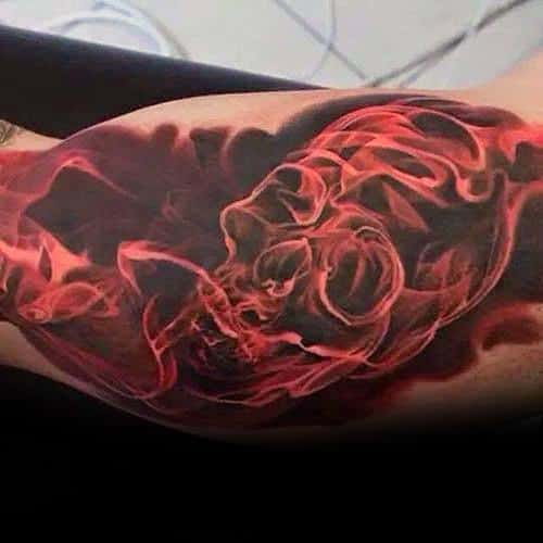mens-tattoo-ideas-with-flaming-skull-design-on-inner-arm-bicep