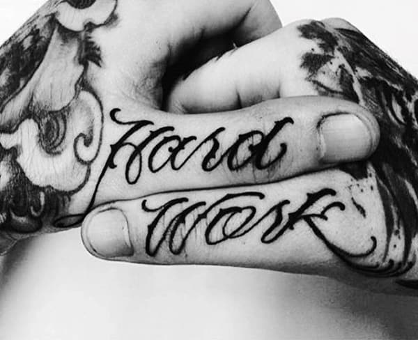 Mens Words Thumb Tattoo With Hard Work Lettering