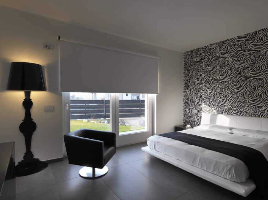 minimalist black and white bedroom pattern feature wall gray tile floor