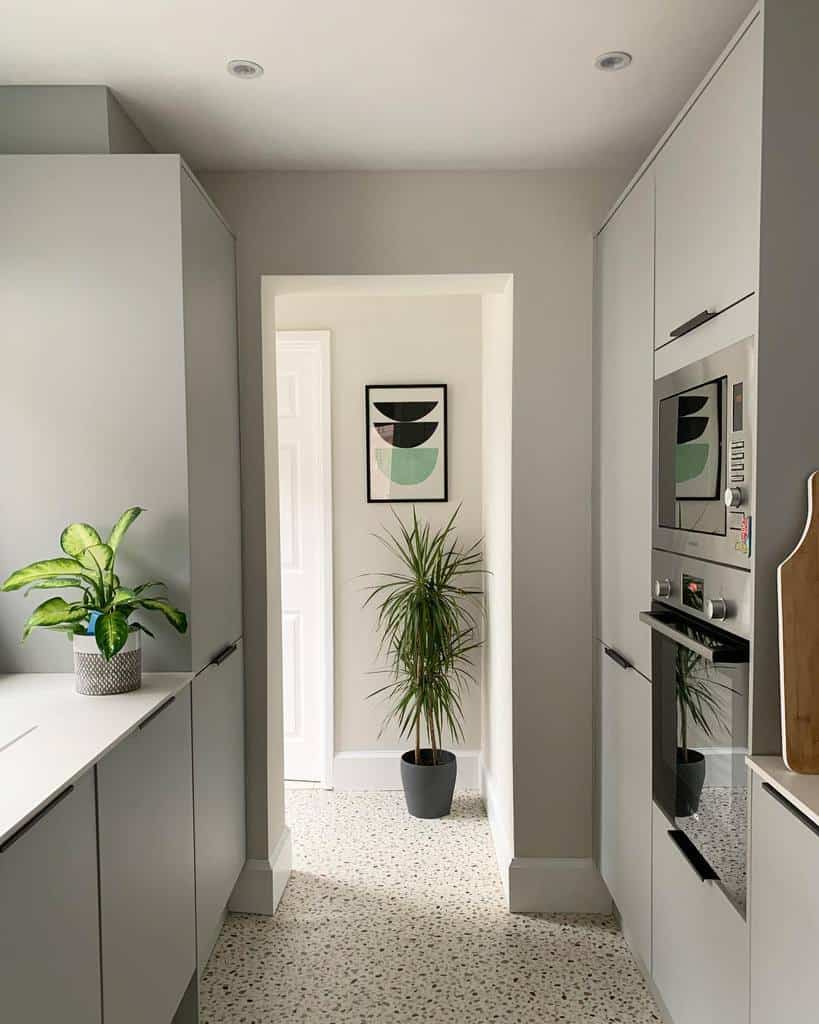 minimalist galley kitchen gray and white cabinets mosaic floor tiles 