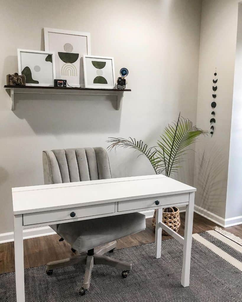 minimalist home office wood desk with drawers wall shelf with framed art gray office chair wicker basket 