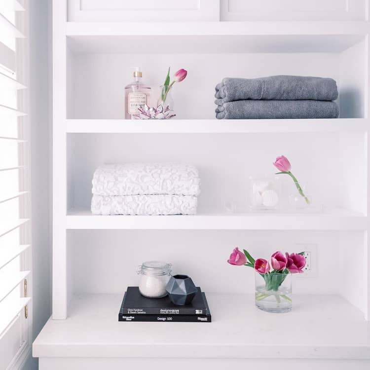 simple bathroom shelf with flowers and towels