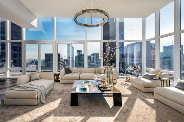 luxury apartment living room ceiling to floor windows white sofas 