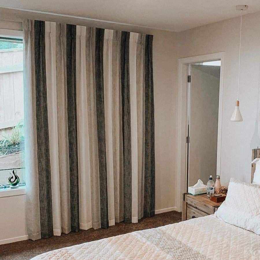 rustic bedroom wood bedside table stripe curtains pendant light