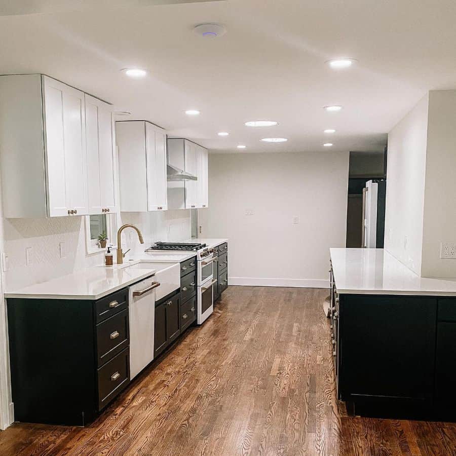 modern galley kitchen white and black cabinets wood vinyl flooring 