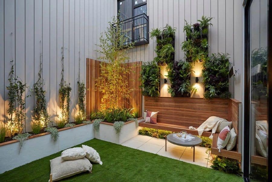 modern garden white tile patio wood bench artificial grass vertical wall planters 