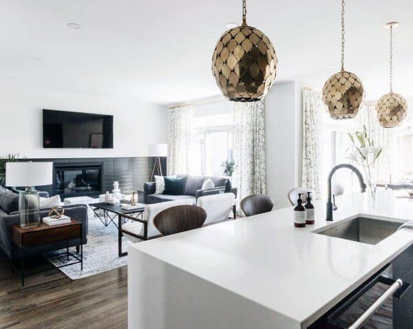 modern living room kitchen marble island fireplace grey sofas vinyl wood flooring gold pendant lights 