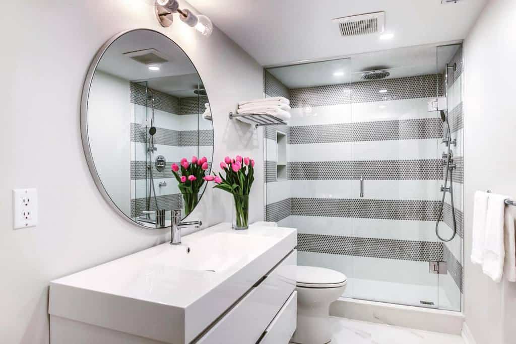 modern small basement bathroom with mosaic tile shower 