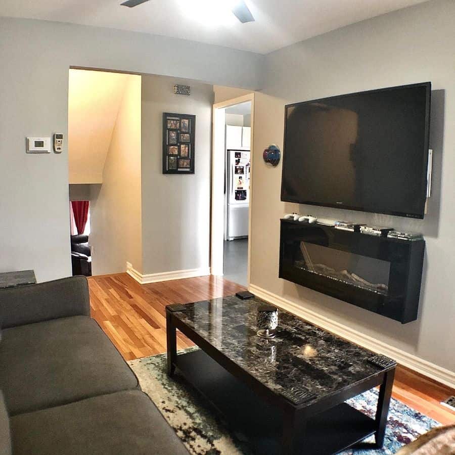 small living room with wall mounted tv and fireplace 