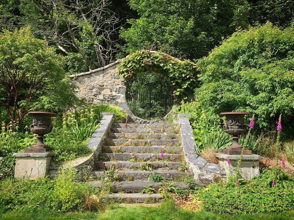 stone moon gate and steps large planters wall vines