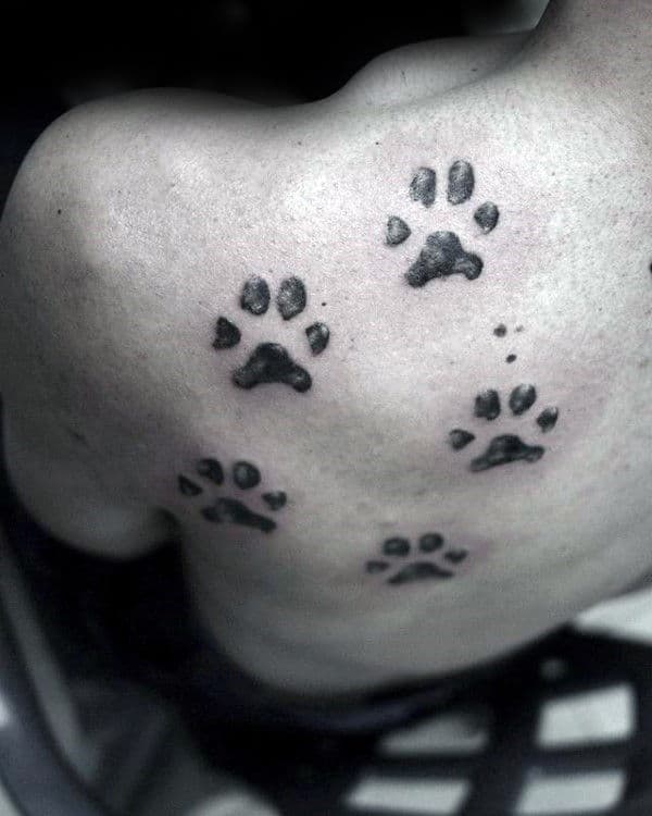 Multiple Dog Paw Prints Mens Back Tattoo