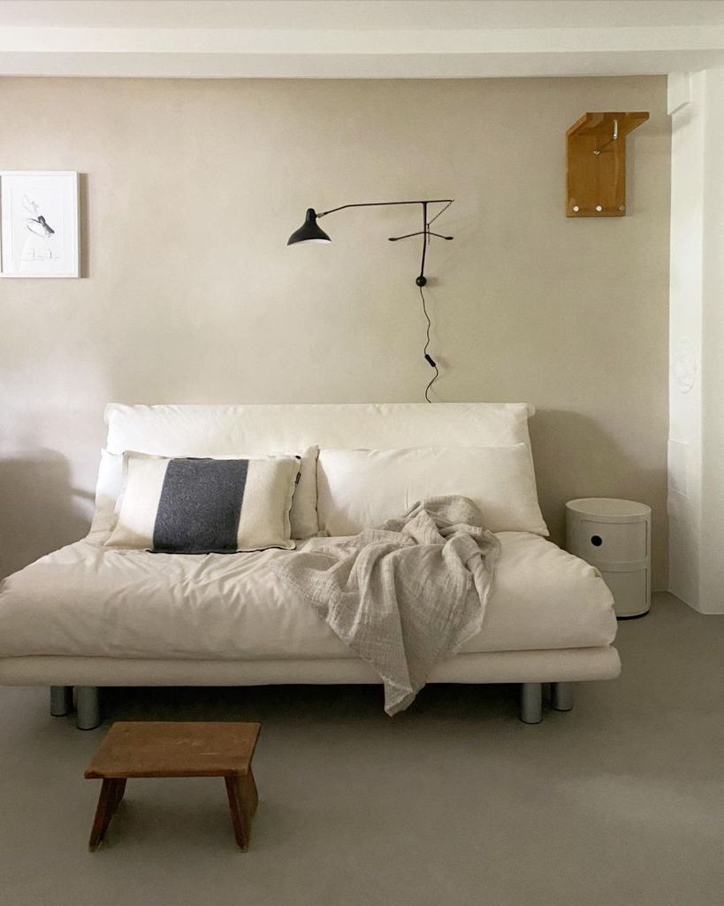 white futon with wall lamp