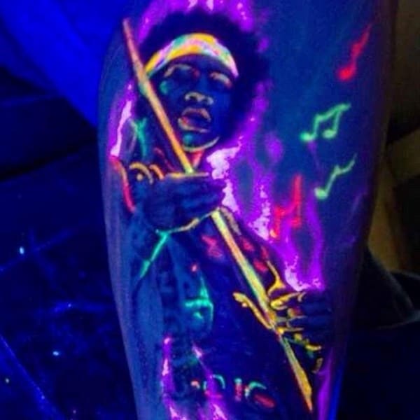 Musical Themed Guys Glow In The Dark Tattoo On Leg