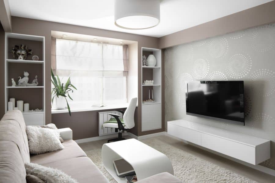 small muted color living room with sofa and recessed wall shelves 