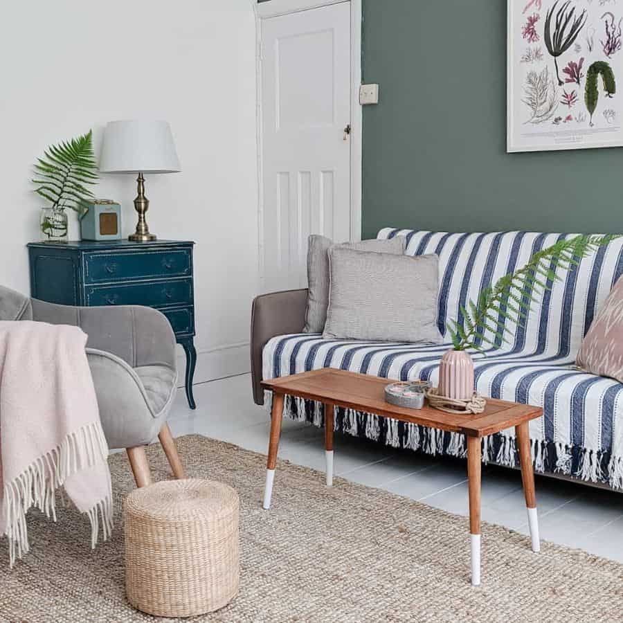 cottage living room with gree accent wall and gray sofa