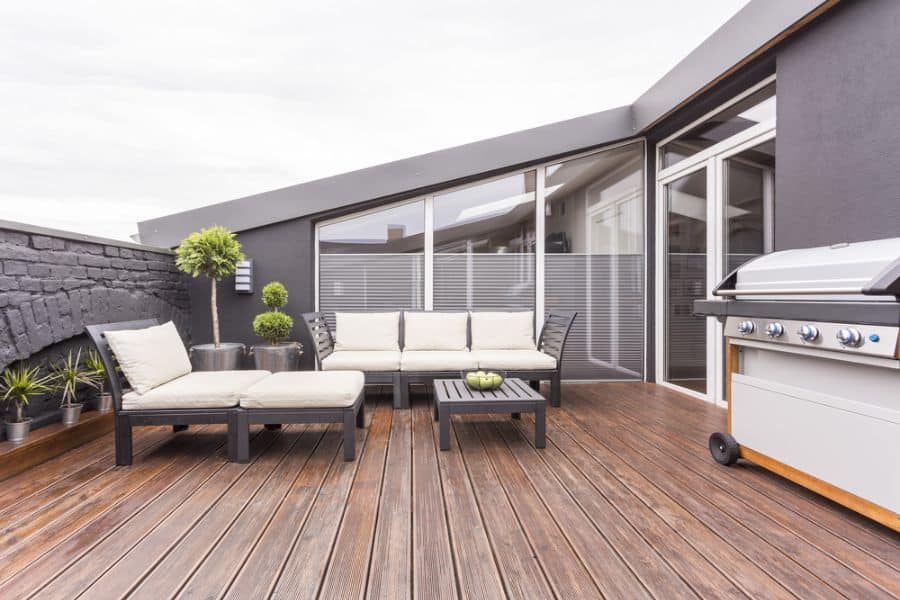 rooftop wood deck patio with sofa and bbq