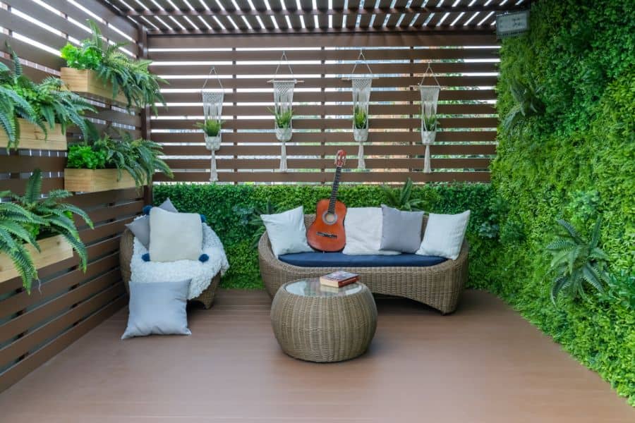 small wood deck patio with wicker furniture 